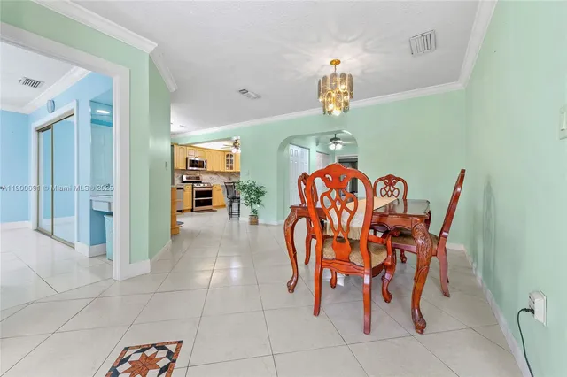 a dining room filled with furniture and a chandelier