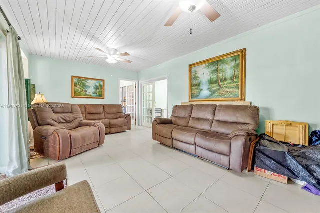 a living room with furniture and a ceiling fan