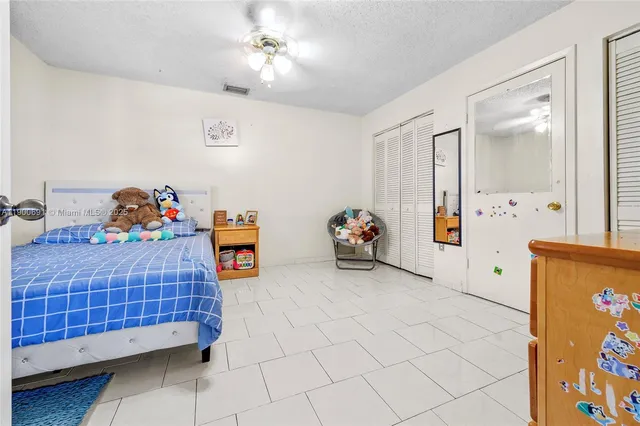 a bedroom with a bed and a dresser in it