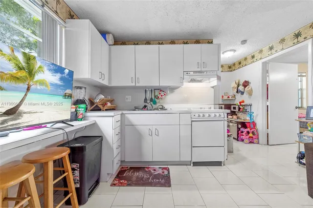 a utility room with cabinets washer and dryer