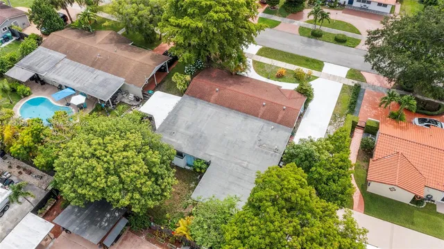 an aerial view of a house with a yard and garden