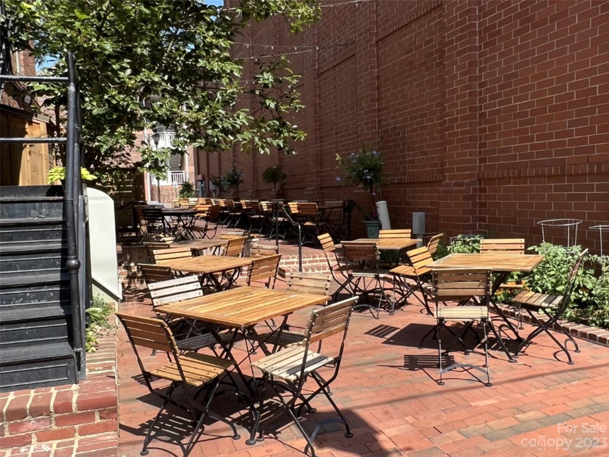 157 Copper Pne Lane, Unit 7 Davidson, NC 28036 - Photo 19 of 20 a view of a patio with table and chairs and potted plants