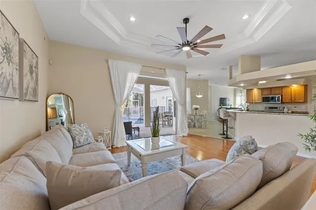 a living room with furniture and a view of kitchen