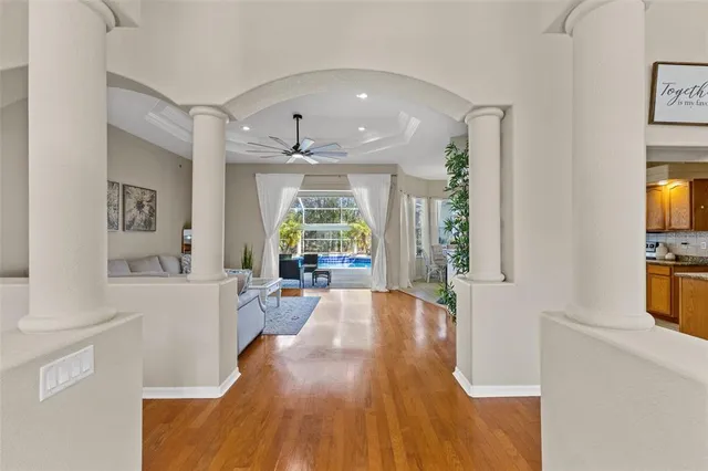 a living room with furniture and a wooden floor