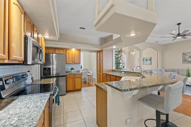 a view of a dining room with furniture and a chandelier