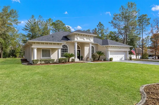 a front view of a house with a garden and plants