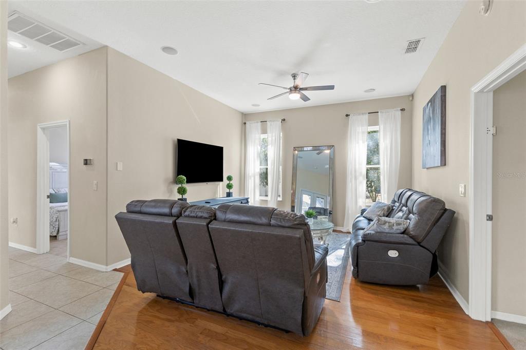 14071 Linden Drive Spring Hill, FL 34609 - Photo 39 of 77 a living room with furniture and a flat screen tv
