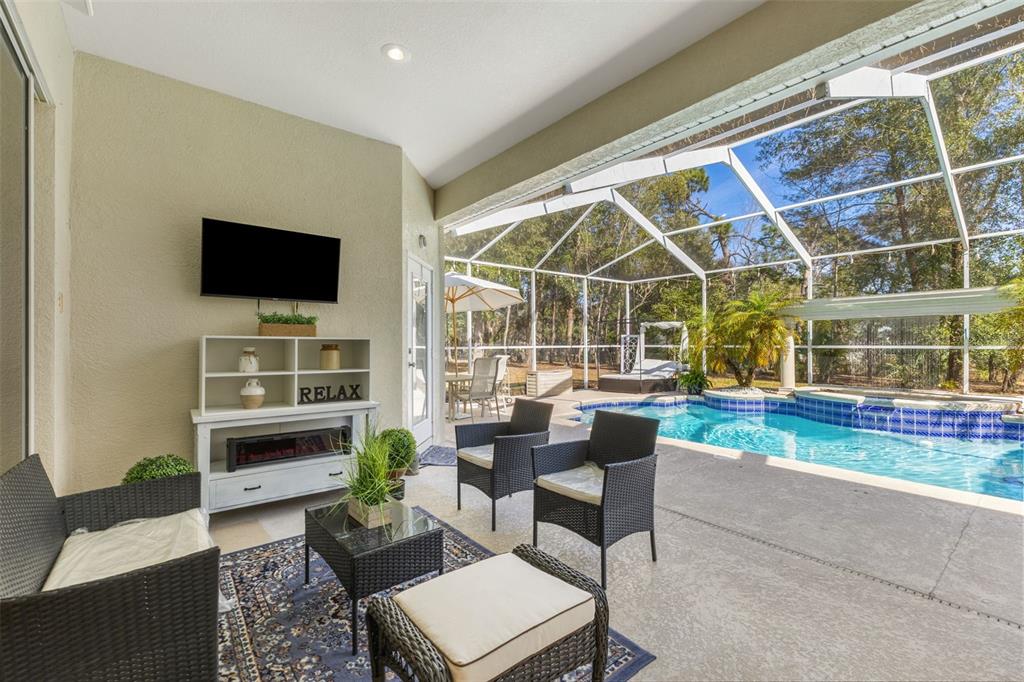 14071 Linden Drive Spring Hill, FL 34609 - Photo 42 of 77 a living room with furniture and a flat screen tv