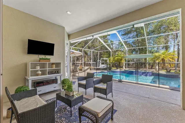 an aerial view of a house with yard swimming pool and outdoor seating