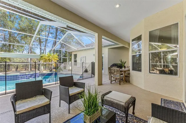 an aerial view of residential house with outdoor space and trees all around