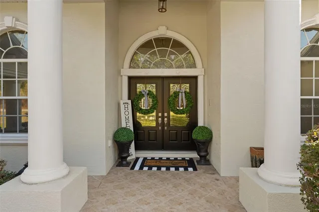 a living room with a furniture and a potted plant