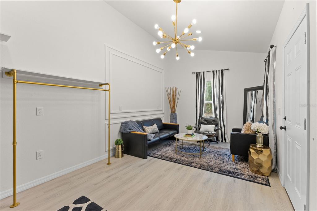 14071 Linden Drive Spring Hill, FL 34609 - Photo 55 of 77 a living room with furniture and chandelier