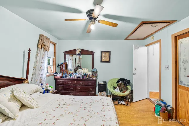 a bedroom with a bed and ceiling fan