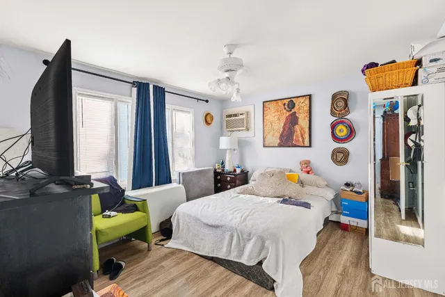 a bedroom with bed and a window