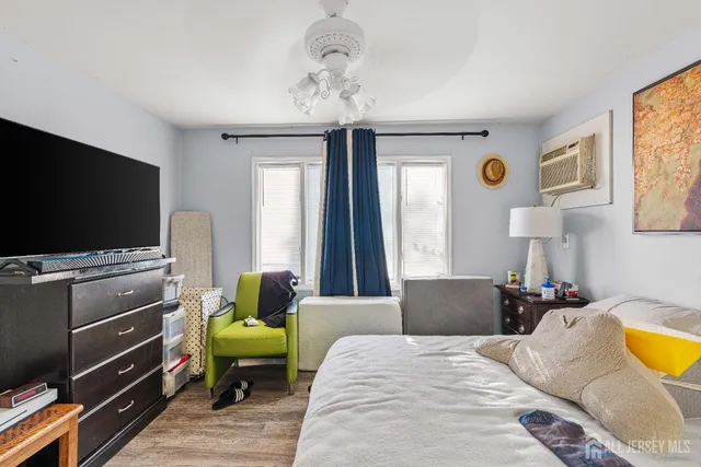 a bedroom with furniture and a flat screen tv