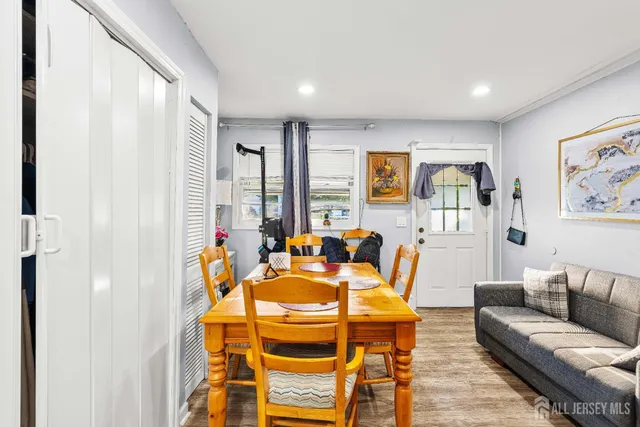a living room with patio furniture and a large window