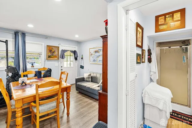 a view of a livingroom with furniture a flat screen tv and wooden floor
