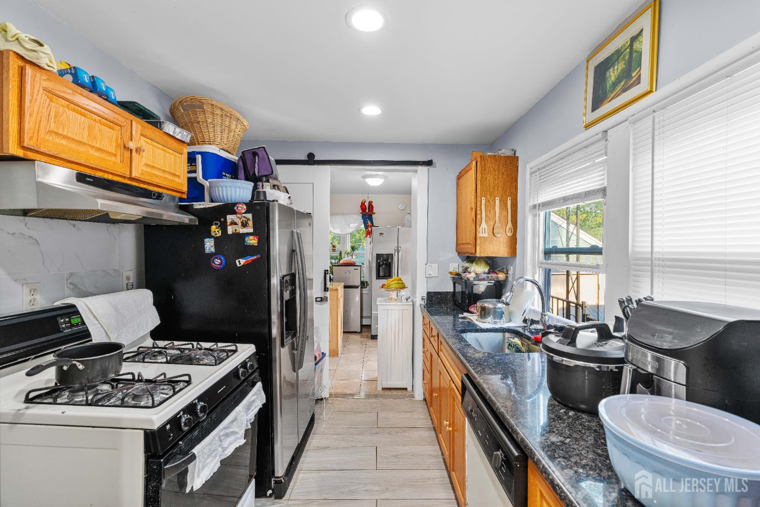 651 Fairview Avenue Piscataway, NJ 08854 - Photo 23 of 45 a kitchen with a stove a sink and a refrigerator
