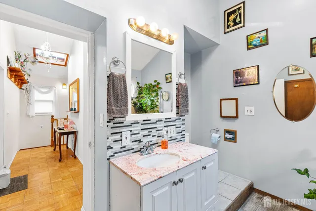 a bathroom with a sink vanity and a mirror