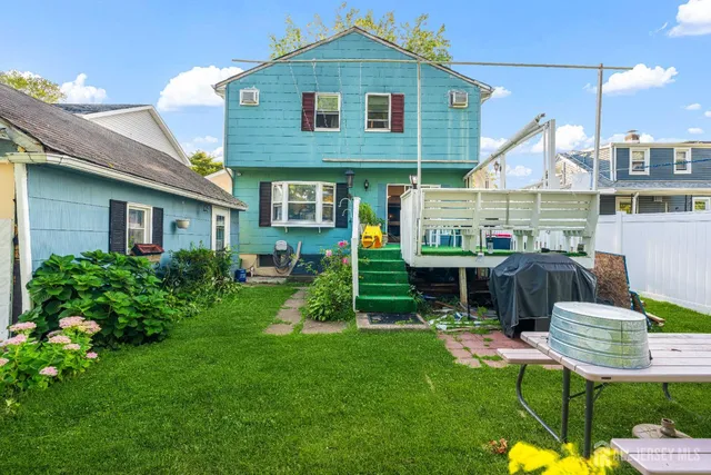 a front view of house with a garden and patio