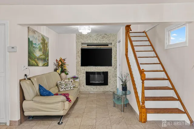a living room with furniture a fireplace and a flat screen tv