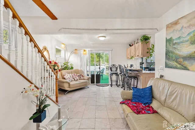 a living room with furniture and a painting on the wall