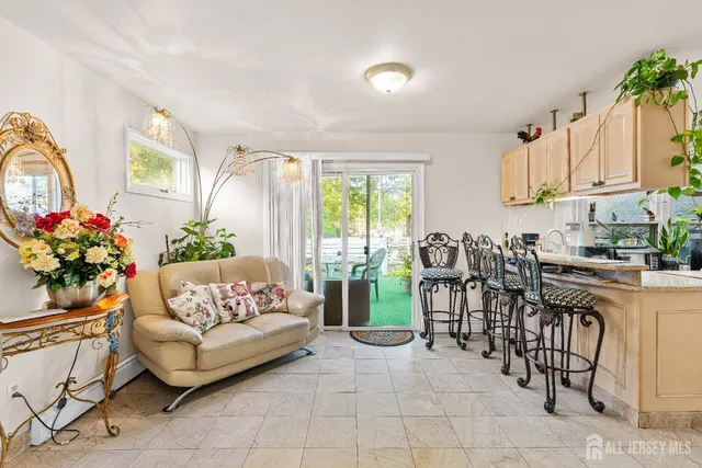 a living room with furniture a chandelier and a dining table