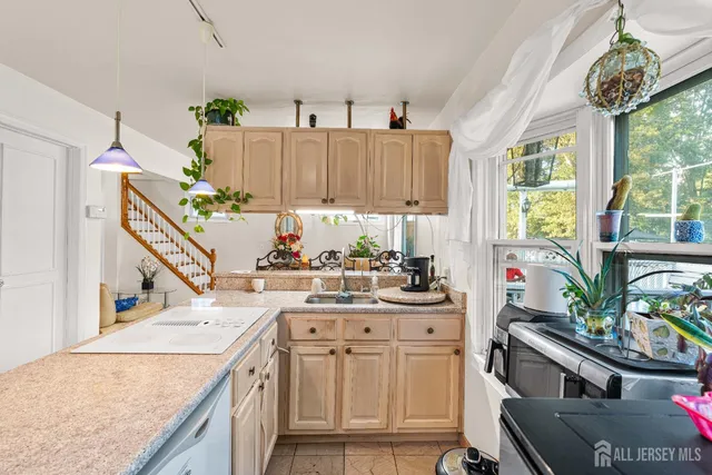 a kitchen with a sink stove and cabinets