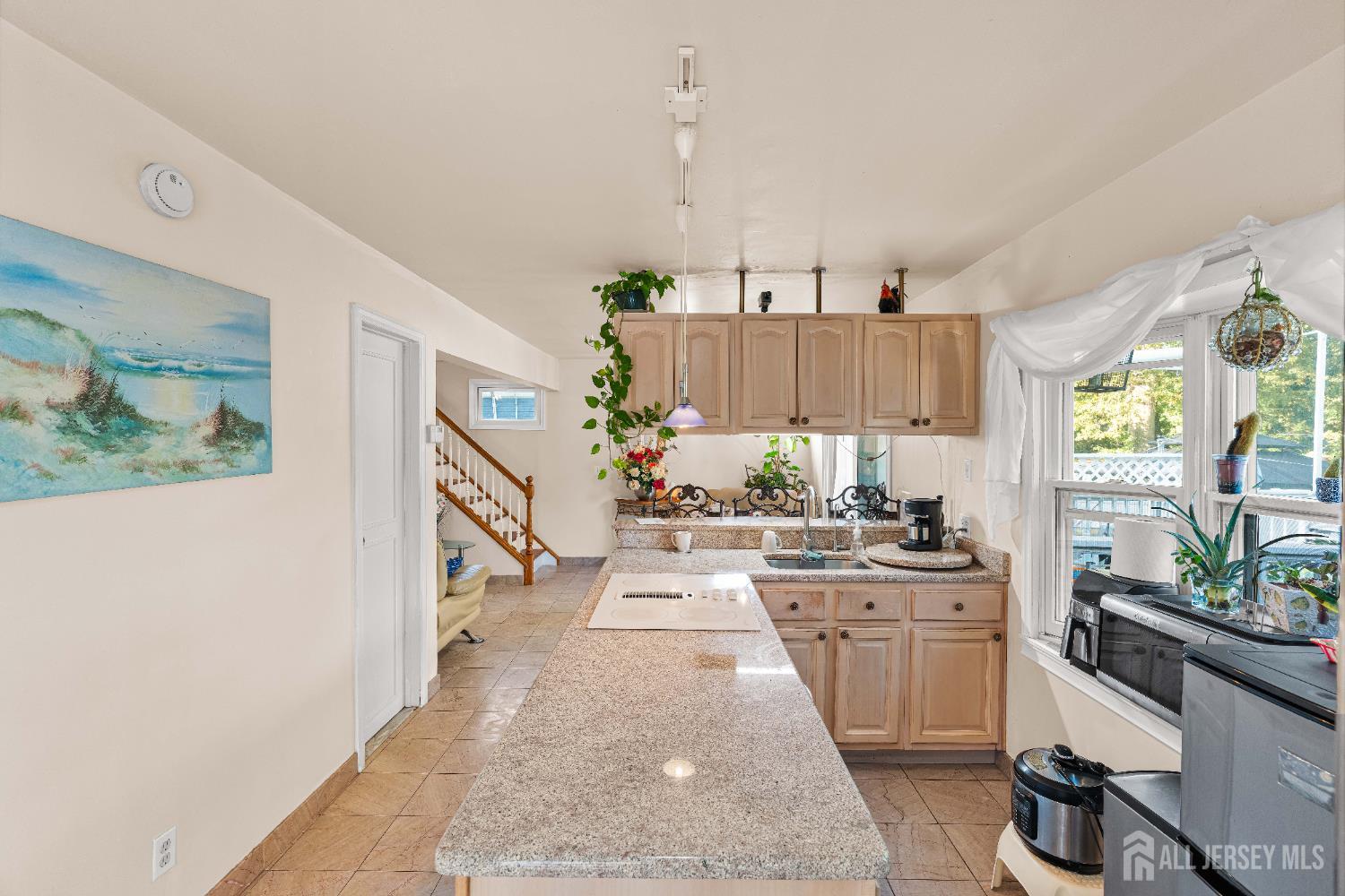 651 Fairview Avenue Piscataway, NJ 08854 - Photo 10 of 45 a kitchen with granite countertop a stove a sink and a refrigerator