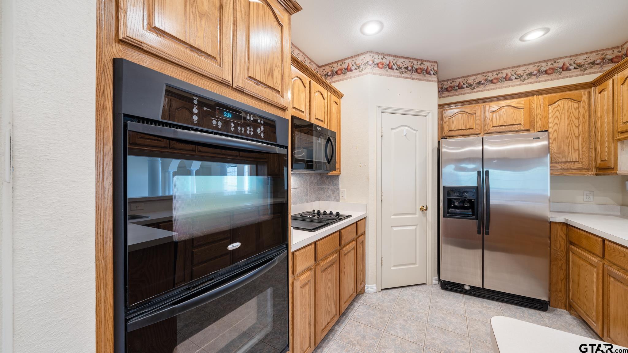 291 VZ County Road Canton, TX 75103 - Photo 13 of 42 a kitchen with stainless steel appliances granite countertop a refrigerator and a stove