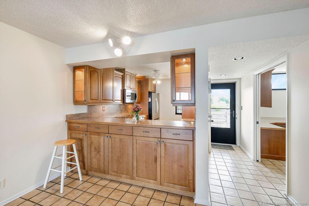 1950 Southwest Palm City Road, Unit 14302 Stuart, FL 34994 - Photo 16 of 62 a kitchen with stainless steel appliances a sink and cabinets