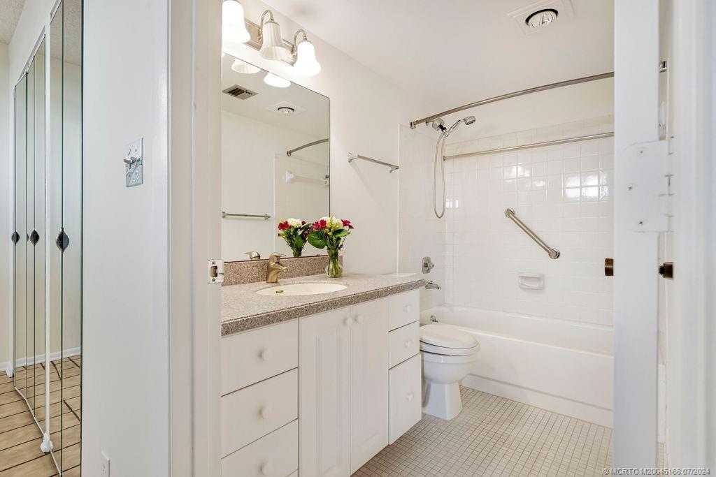 1950 Southwest Palm City Road, Unit 14302 Stuart, FL 34994 - Photo 18 of 62 a bathroom with a sink a toilet and shower