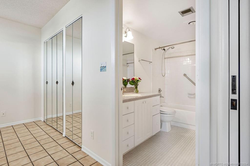 1950 Southwest Palm City Road, Unit 14302 Stuart, FL 34994 - Photo 19 of 62 a bathroom with a shower sink and mirror