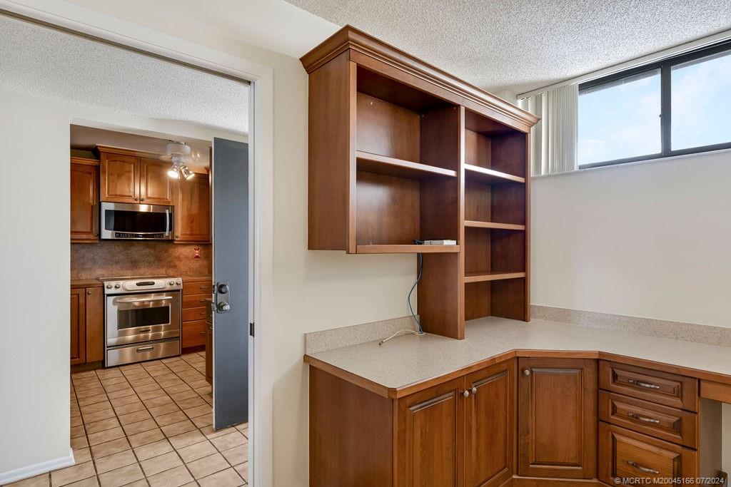 1950 Southwest Palm City Road, Unit 14302 Stuart, FL 34994 - Photo 20 of 62 a kitchen with stainless steel appliances a stove and more cabinets