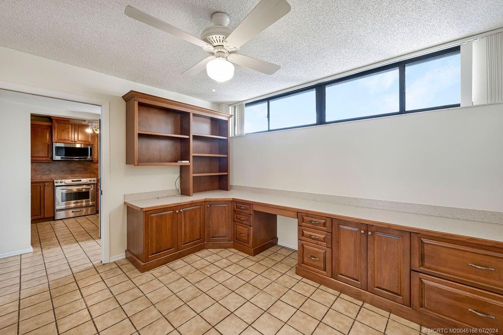 1950 Southwest Palm City Road, Unit 14302 Stuart, FL 34994 - Photo 22 of 62 a kitchen with stainless steel appliances a stove sink and cabinets