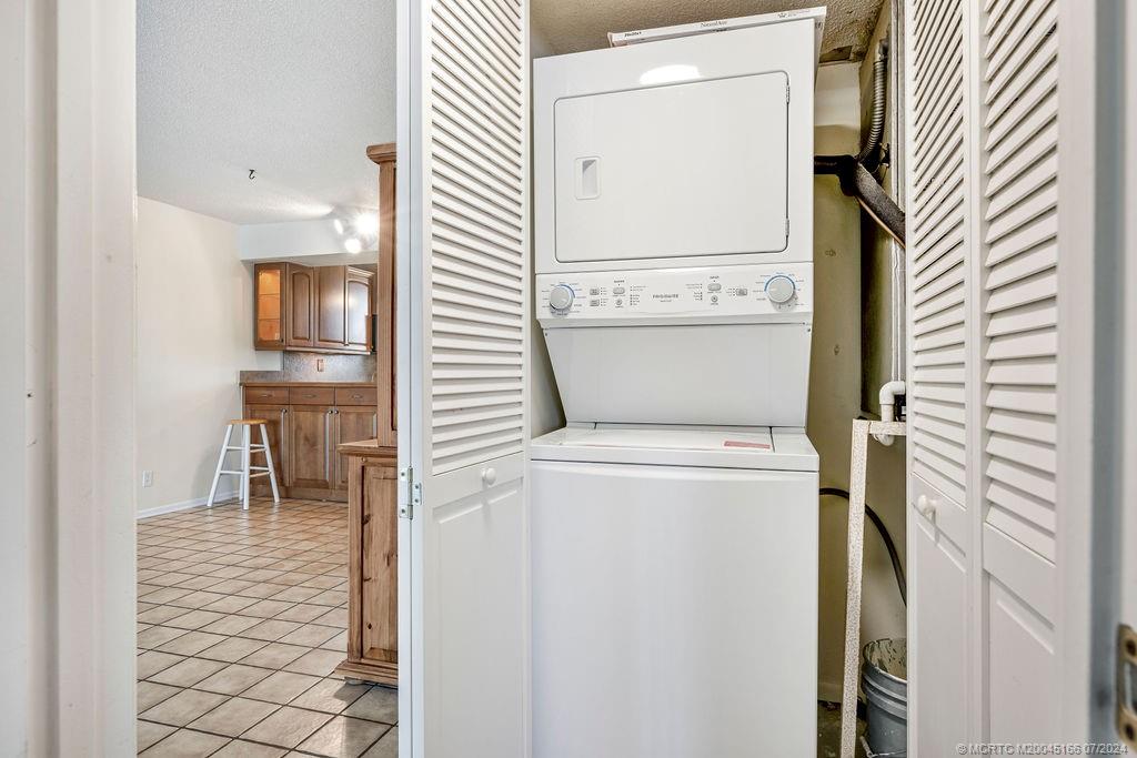 1950 Southwest Palm City Road, Unit 14302 Stuart, FL 34994 - Photo 23 of 62 a view of washer and dryer with wooden door