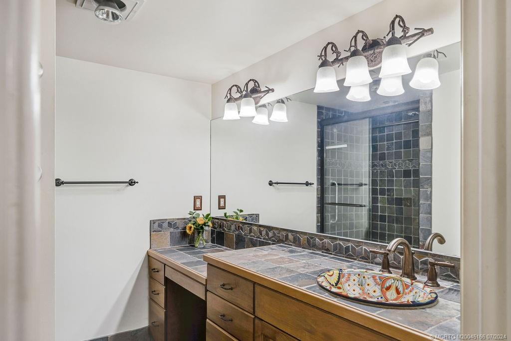 1950 Southwest Palm City Road, Unit 14302 Stuart, FL 34994 - Photo 24 of 62 a bathroom with a sink and a mirror