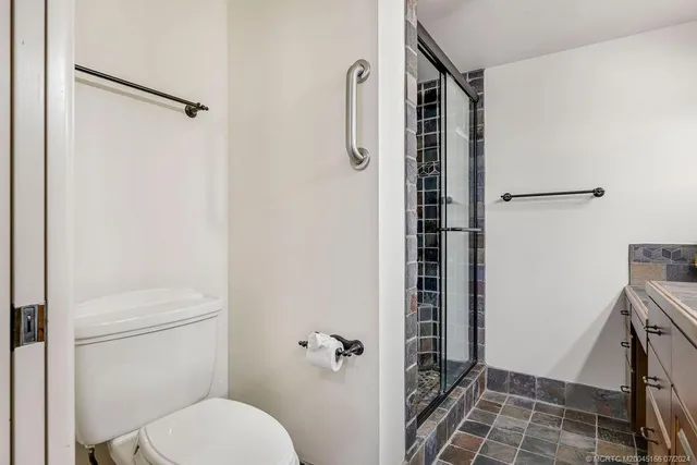 an aerial view of a house with a lake