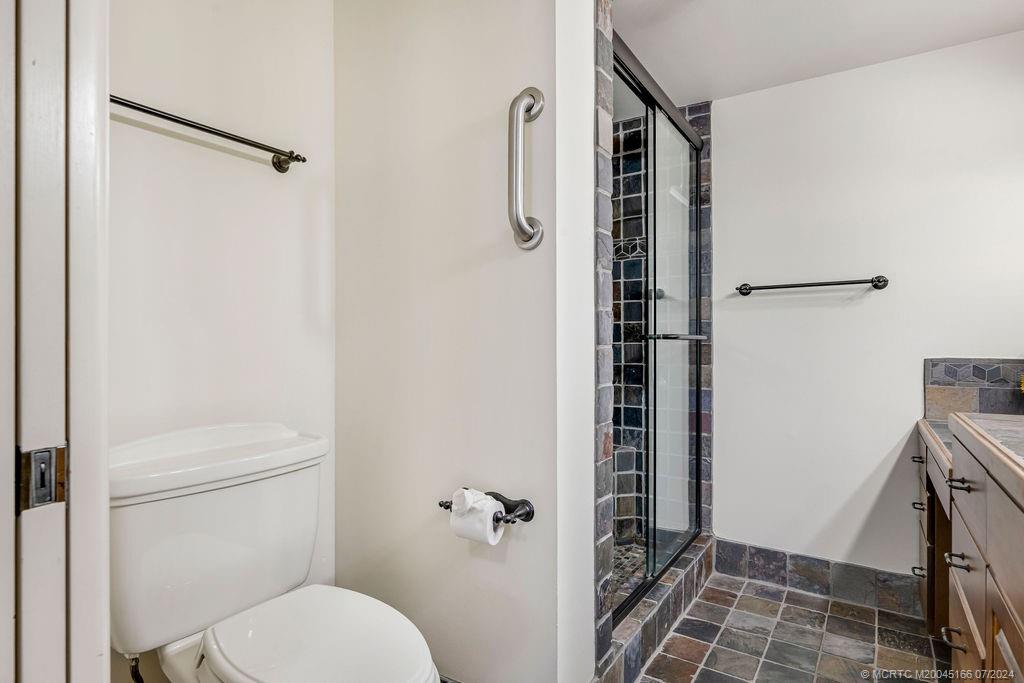 1950 Southwest Palm City Road, Unit 14302 Stuart, FL 34994 - Photo 26 of 62 a bathroom with a shower toilet and sink