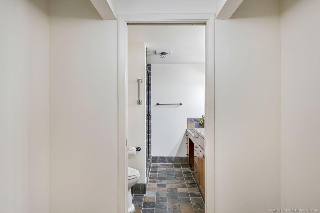 1950 Southwest Palm City Road, Unit 14302 Stuart, FL 34994 - Photo 27 of 62 a bathroom with a granite countertop shower