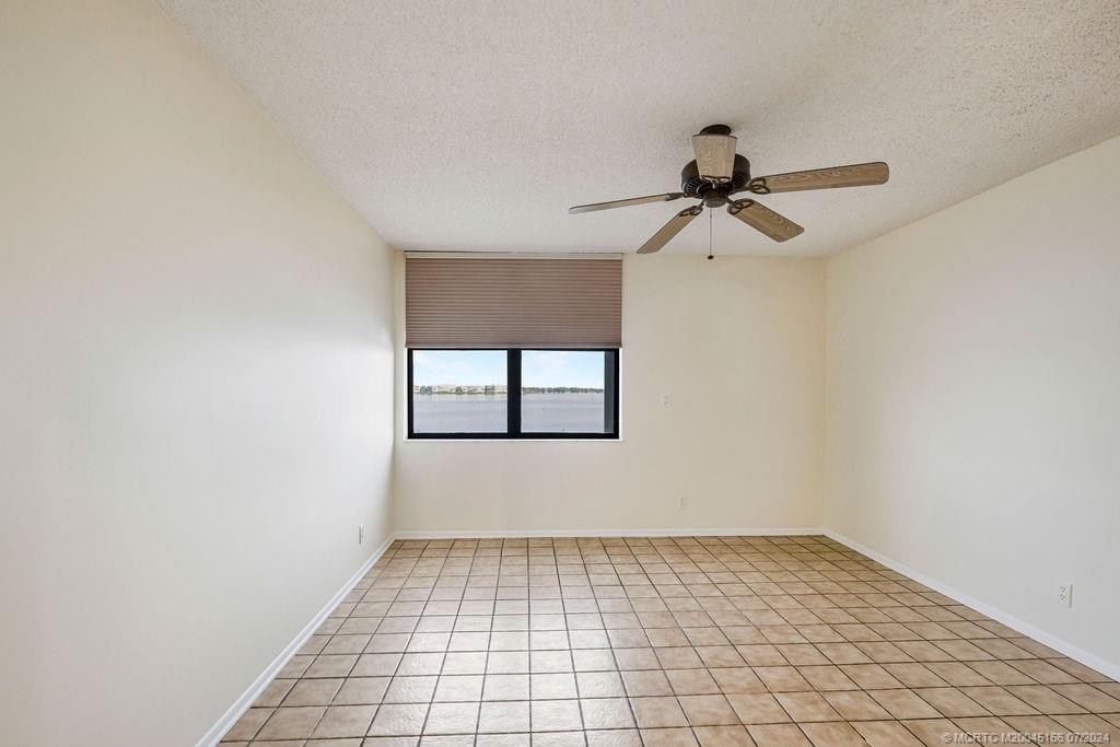 1950 Southwest Palm City Road, Unit 14302 Stuart, FL 34994 - Photo 29 of 62 a view of an empty room and window with a fan
