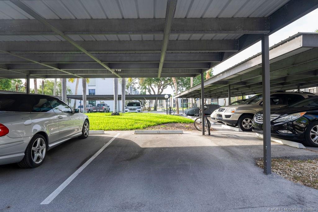 1950 Southwest Palm City Road, Unit 14302 Stuart, FL 34994 - Photo 40 of 62 a view of a cars park in front of a house