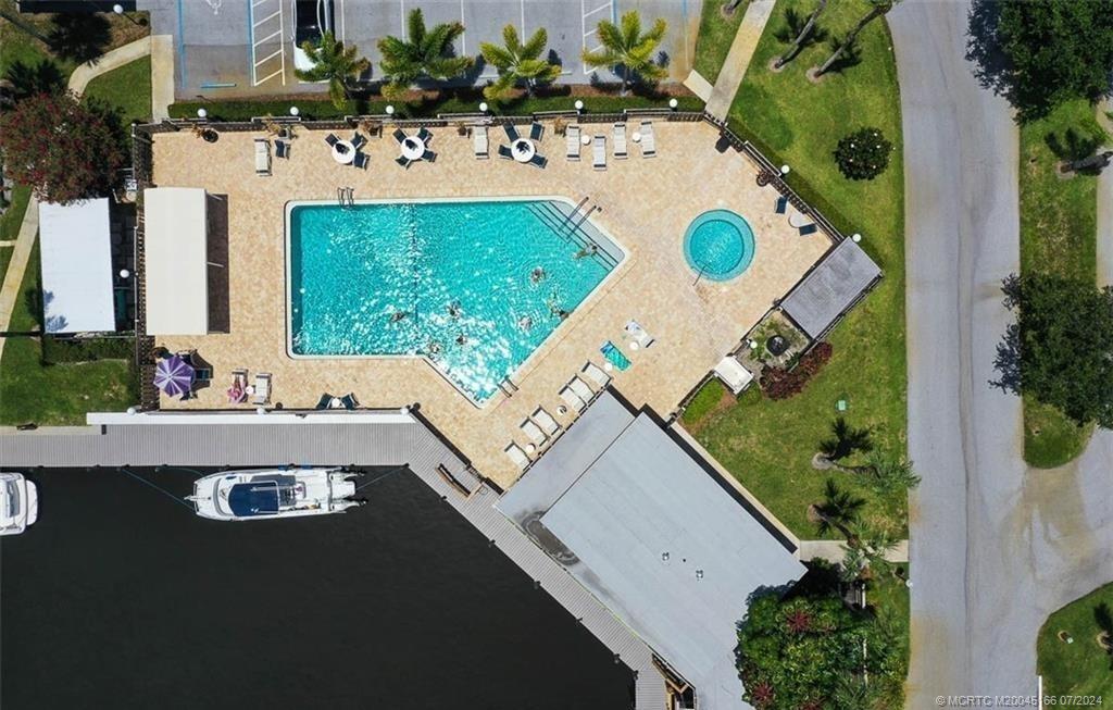 1950 Southwest Palm City Road, Unit 14302 Stuart, FL 34994 - Photo 42 of 62 an aerial view of a house with swimming pool and outdoor seating