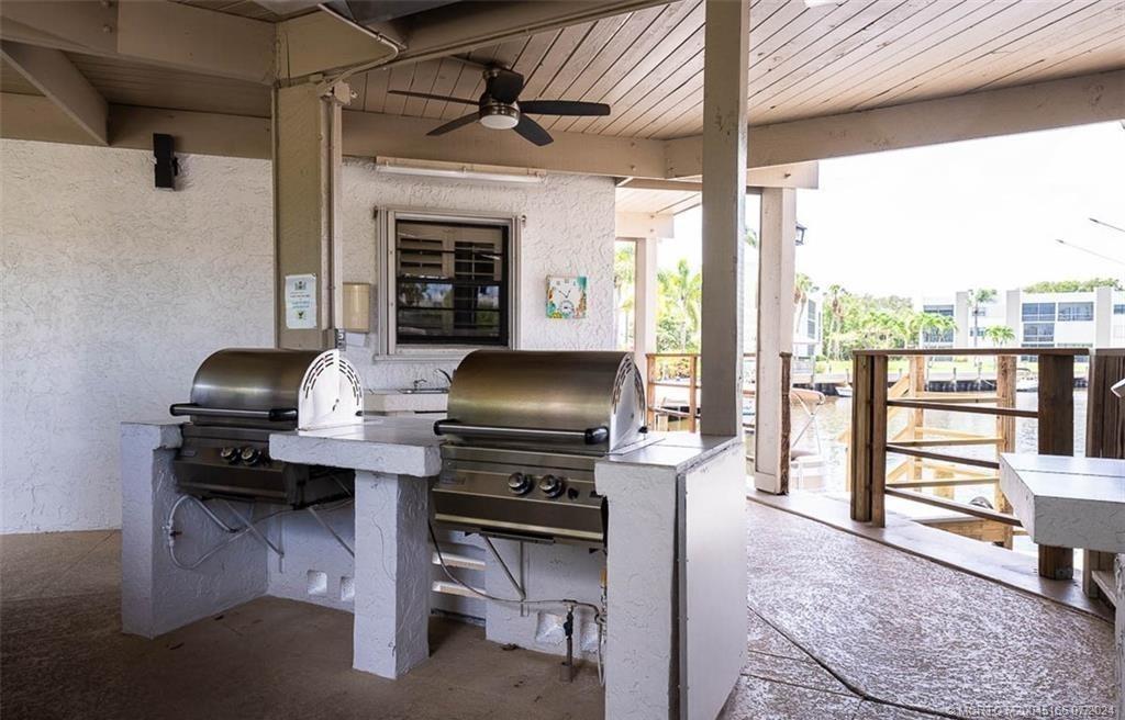 1950 Southwest Palm City Road, Unit 14302 Stuart, FL 34994 - Photo 44 of 62 a living room with furniture a piano and a fireplace