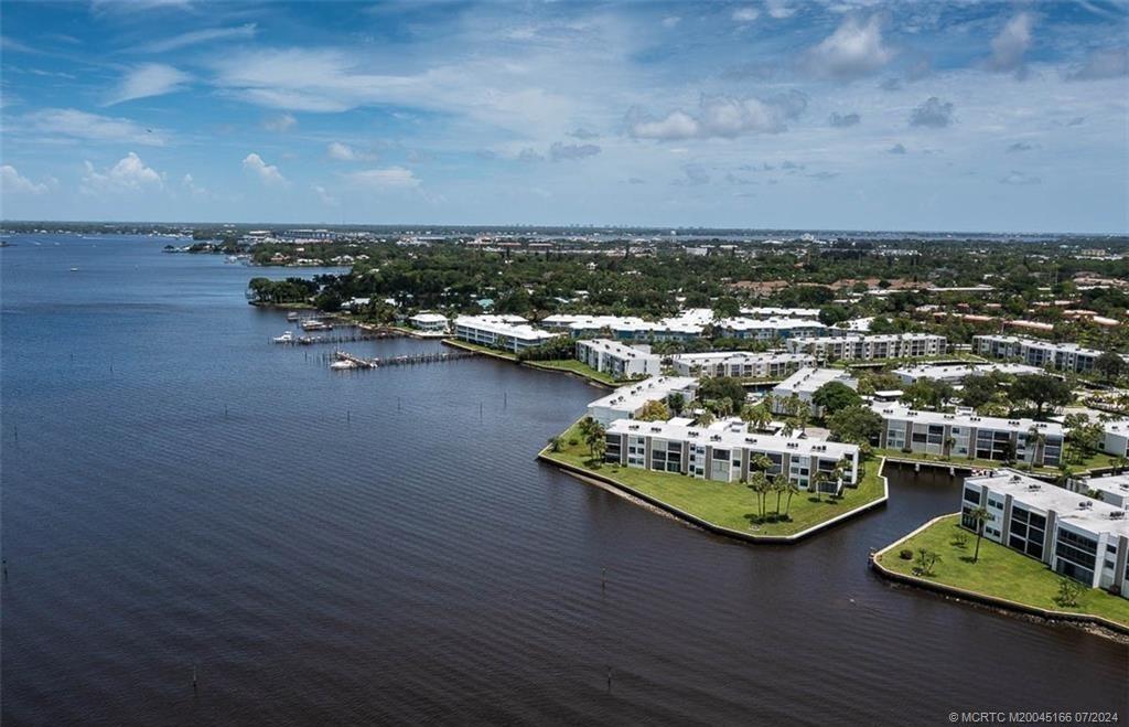 1950 Southwest Palm City Road, Unit 14302 Stuart, FL 34994 - Photo 56 of 62 a view of a lake with lawn chairs