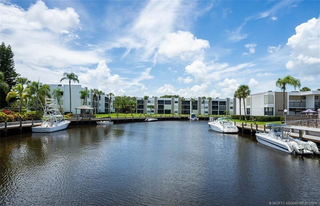 1950 Southwest Palm City Road, Unit 14302 Stuart, FL 34994 - Photo 57 of 62 a view of a lake with boats and trees