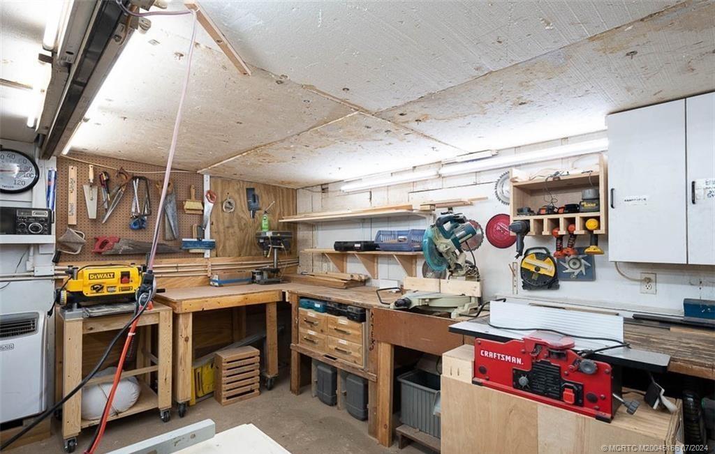 1950 Southwest Palm City Road, Unit 14302 Stuart, FL 34994 - Photo 60 of 62 a kitchen with a sink a stove and chairs