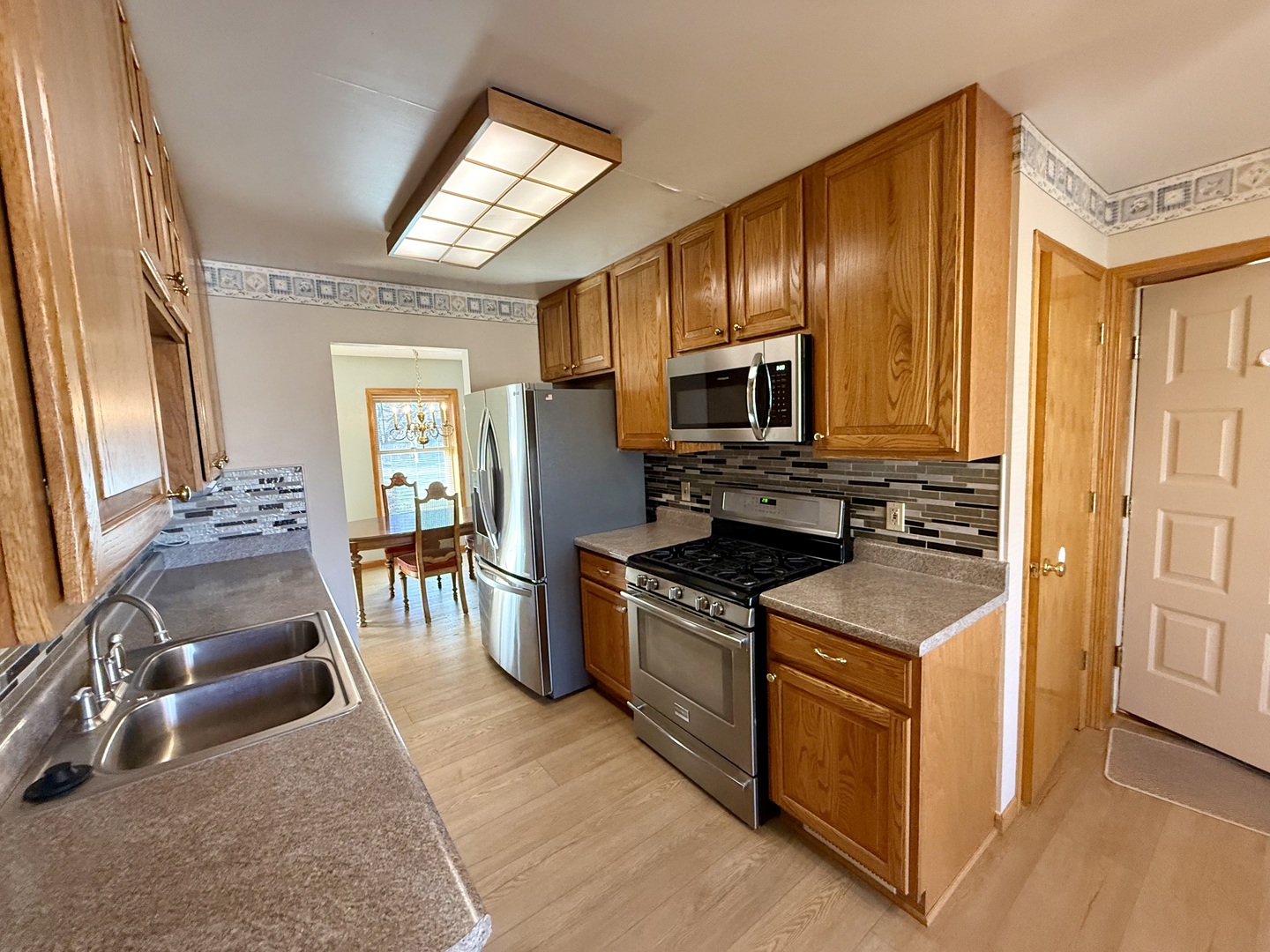 8408 49th Street Coal Valley, IL 61240 - Photo 17 of 43 a kitchen with stainless steel appliances granite countertop a stove a sink and a refrigerator