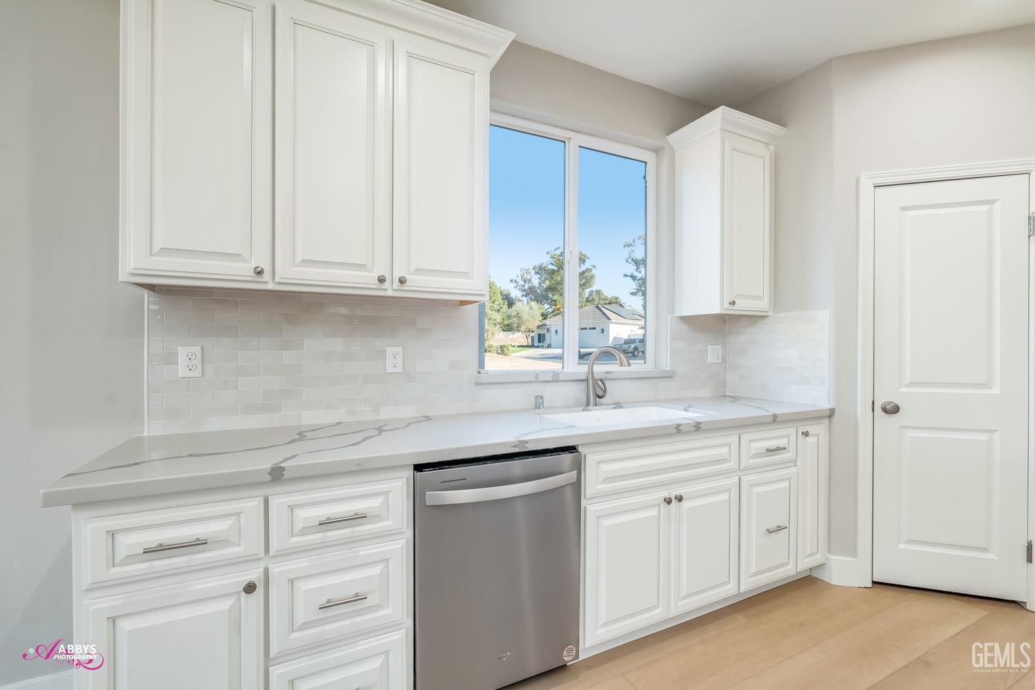 Undisclosed Address Bakersfield, CA 93306 - Photo 17 of 51 a kitchen with white cabinets and white appliances