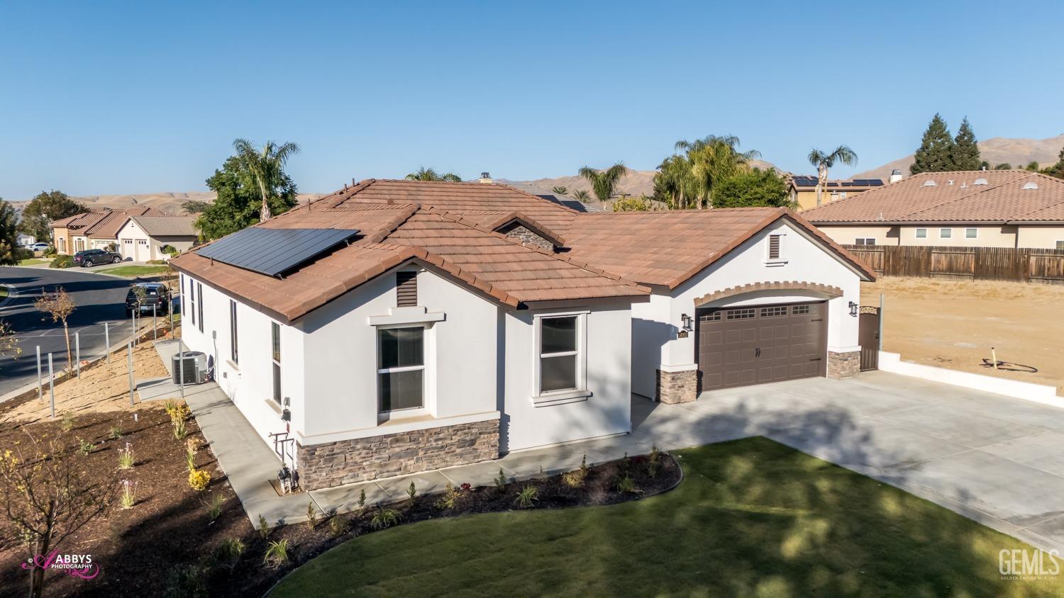 Undisclosed Address Bakersfield, CA 93306 - Photo 41 of 51 a view of a house with a yard and potted plants